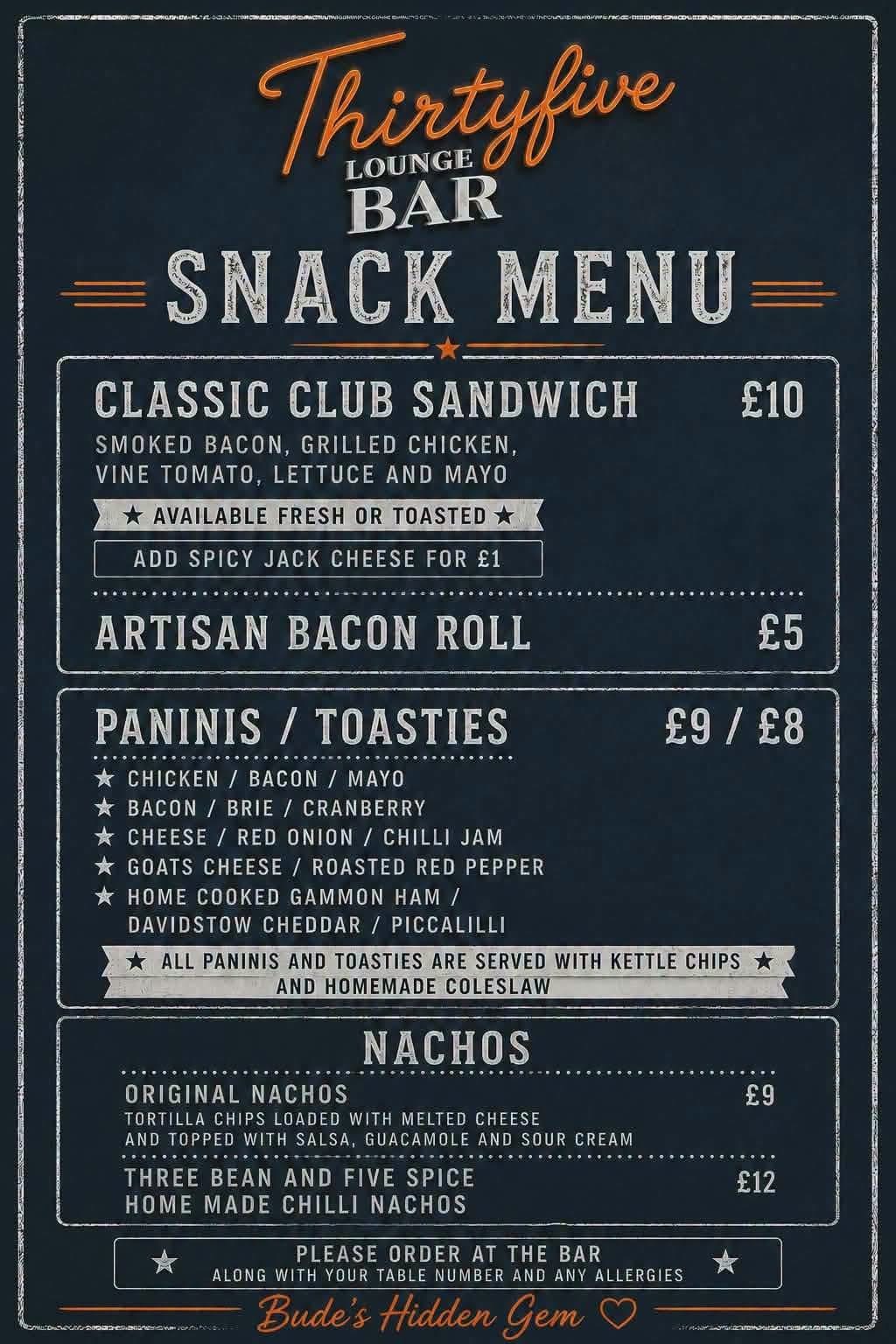 Bar Thirty Five Bude snack menu board — classic club sandwich £10, artisan bacon roll £5, paninis and toasties £9/£8, and nachos £9/£12